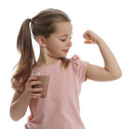 Photo of Cute little girl with glass of chocolate milk showing her strength on white background