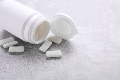 Jar with chewing gums on light grey table