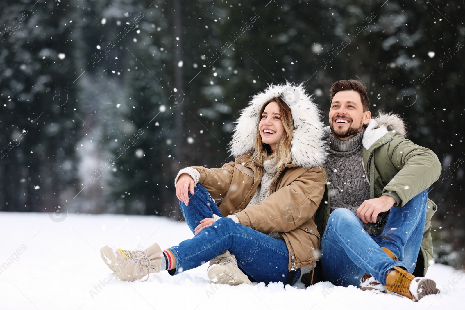 Photo of Couple spending time outdoors on snowy day. Winter vacation