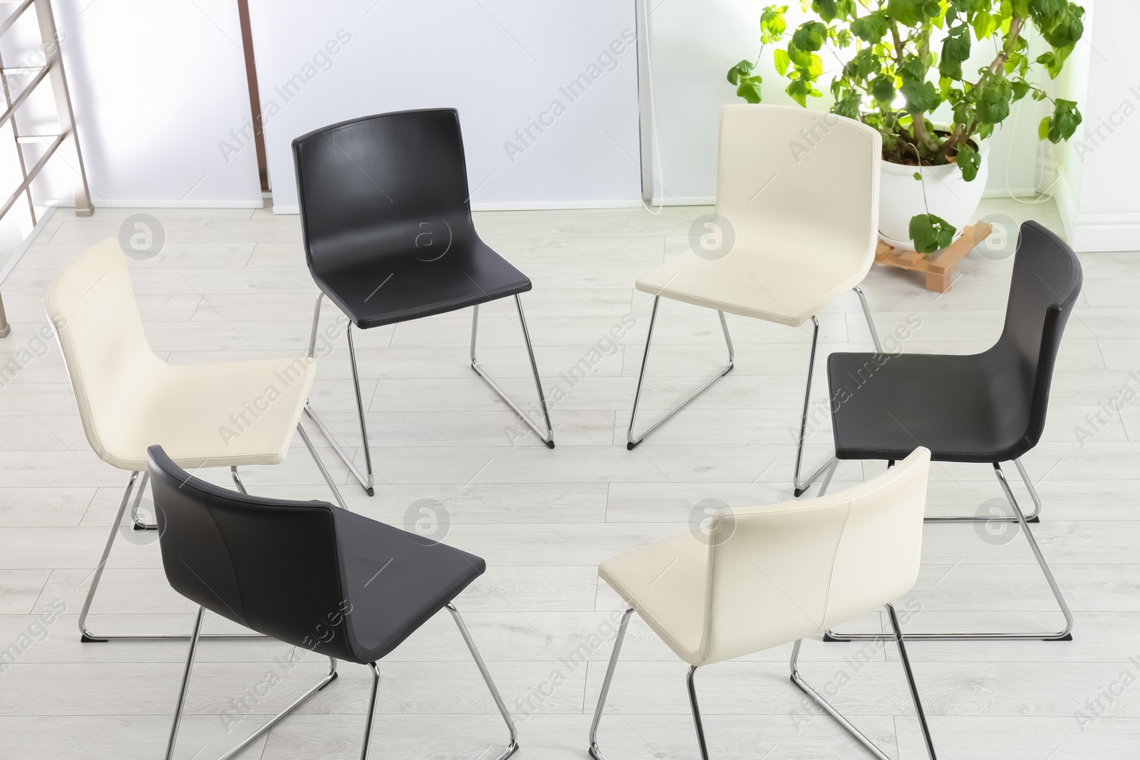 Photo of Empty chairs prepared for group psychotherapy session indoors