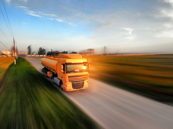 Image of Logistics concept. Truck on country road, motion blur effect 