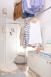 Modern dressing room with different stylish clothes and accessories