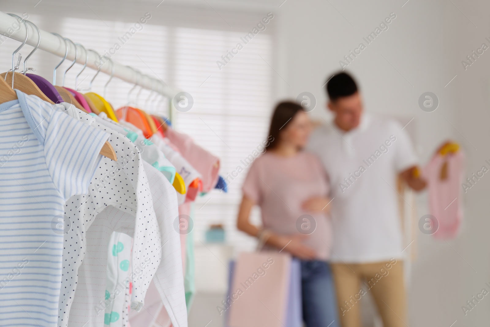 Photo of Baby clothes hanging on rack in store. Shopping concept