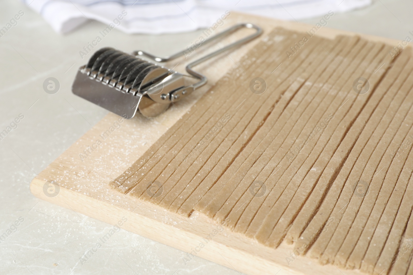 Photo of Uncooked soba (buckwheat noodles) on wooden board