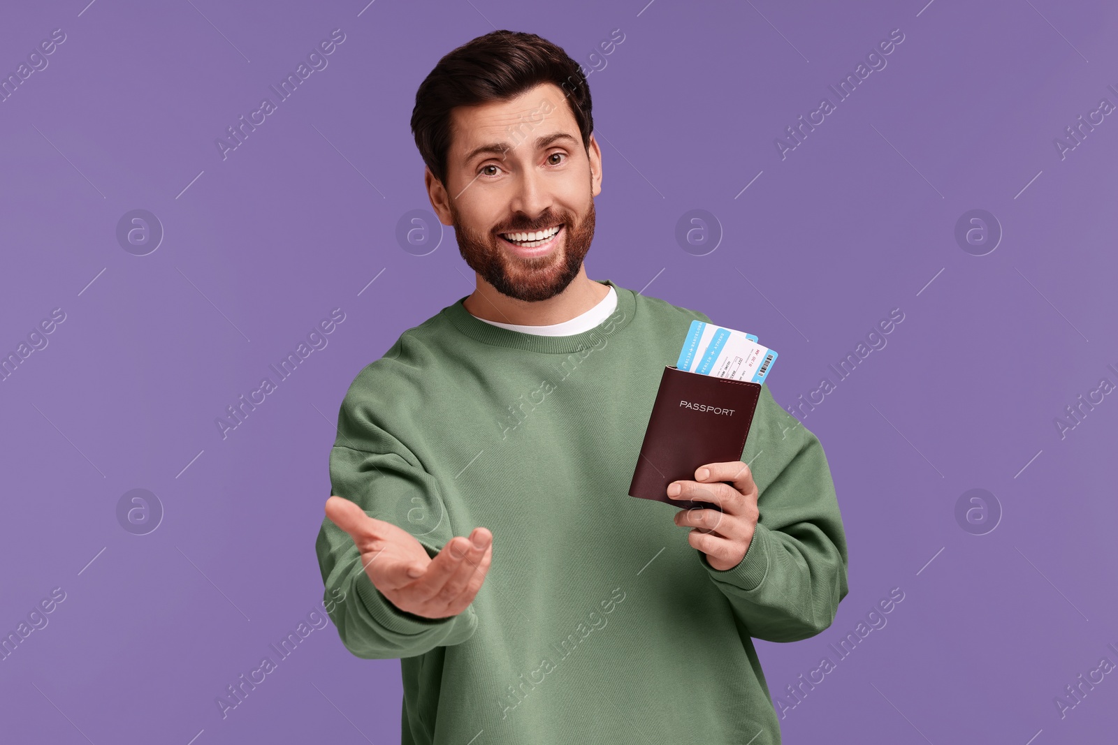 Photo of Smiling man with passport and tickets on purple background