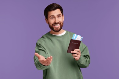 Photo of Smiling man with passport and tickets on purple background