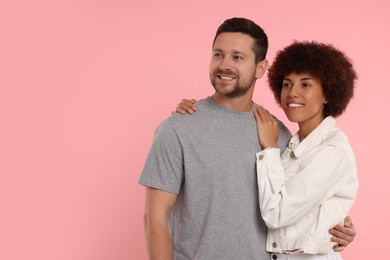 International dating. Portrait of lovely couple on pink background. Space for text