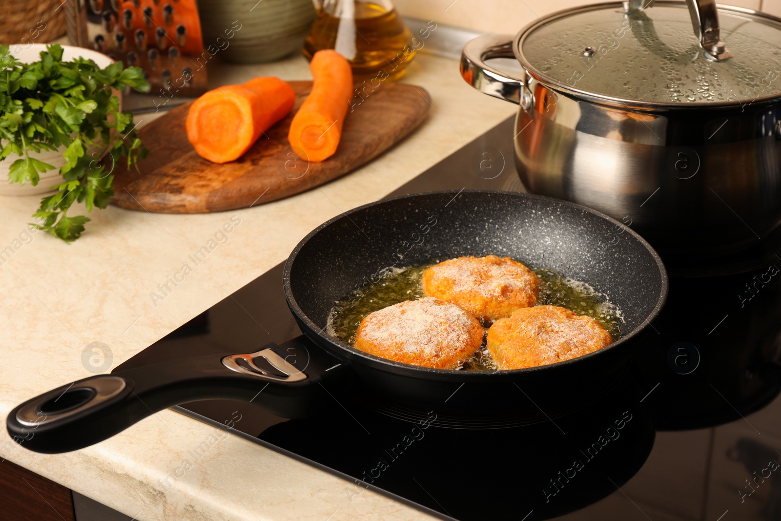 Photo of Cooking vegan cutlets in frying pan on stove