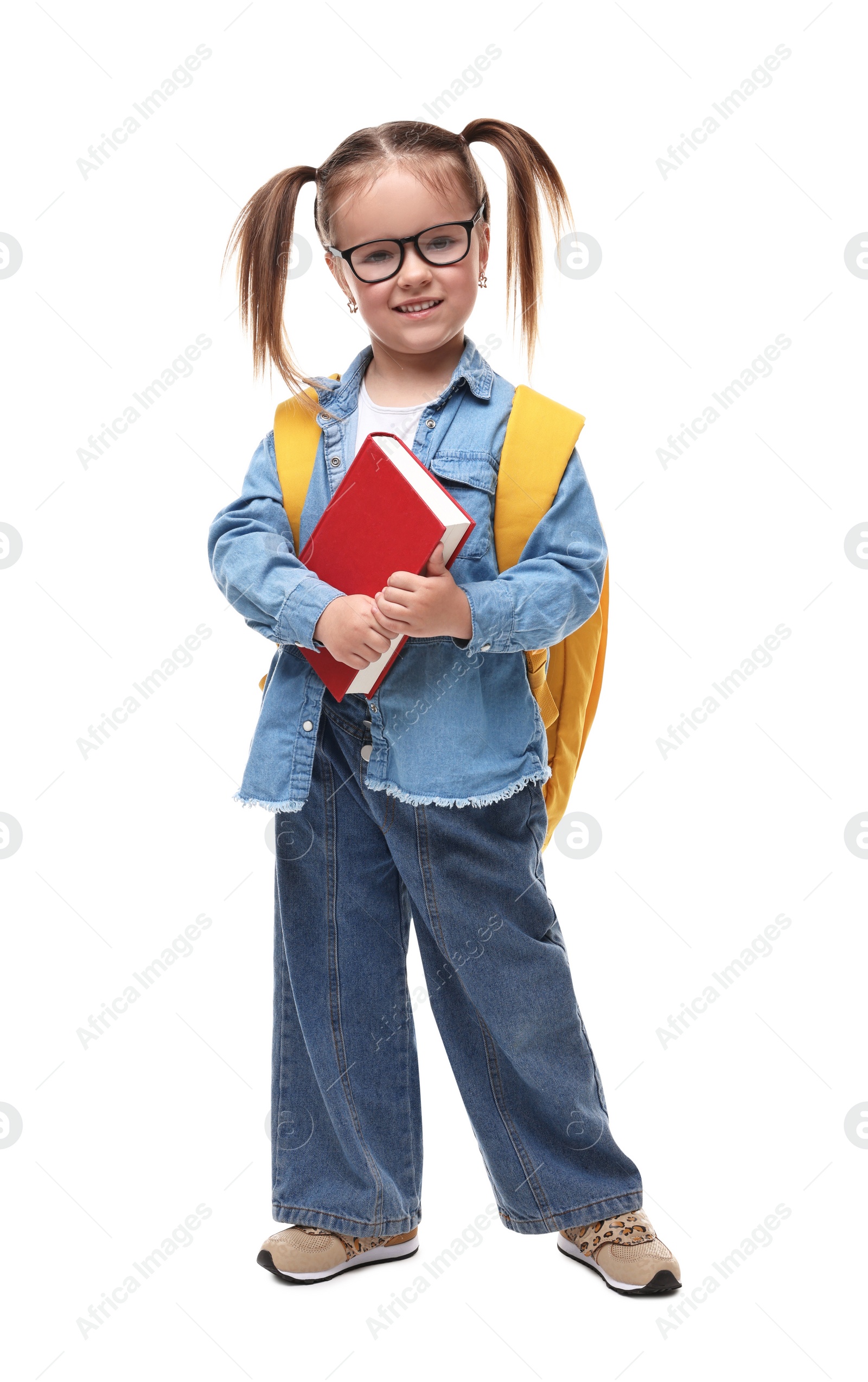 Photo of Cute little girl in glasses with book and backpack on white background