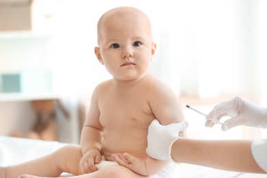 Doctor vaccinating baby in clinic