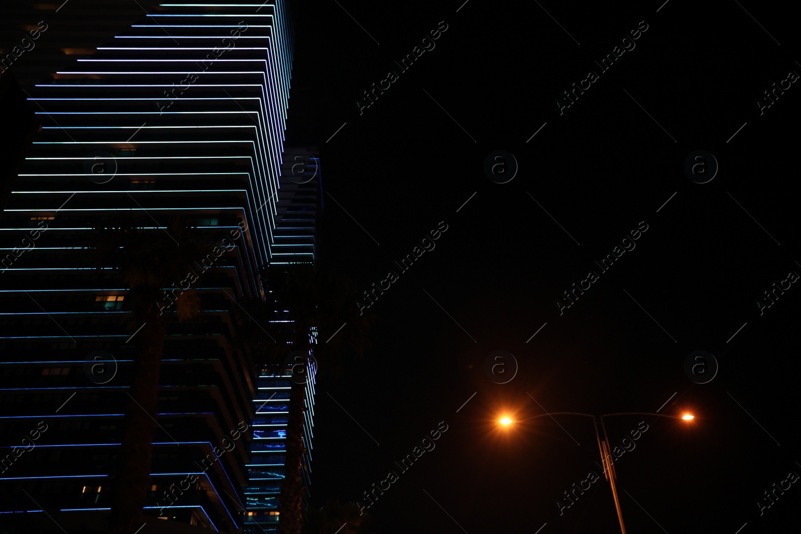 Photo of BATUMI, GEORGIA - JUNE 09, 2022: View of night cityscape with illuminated buildings