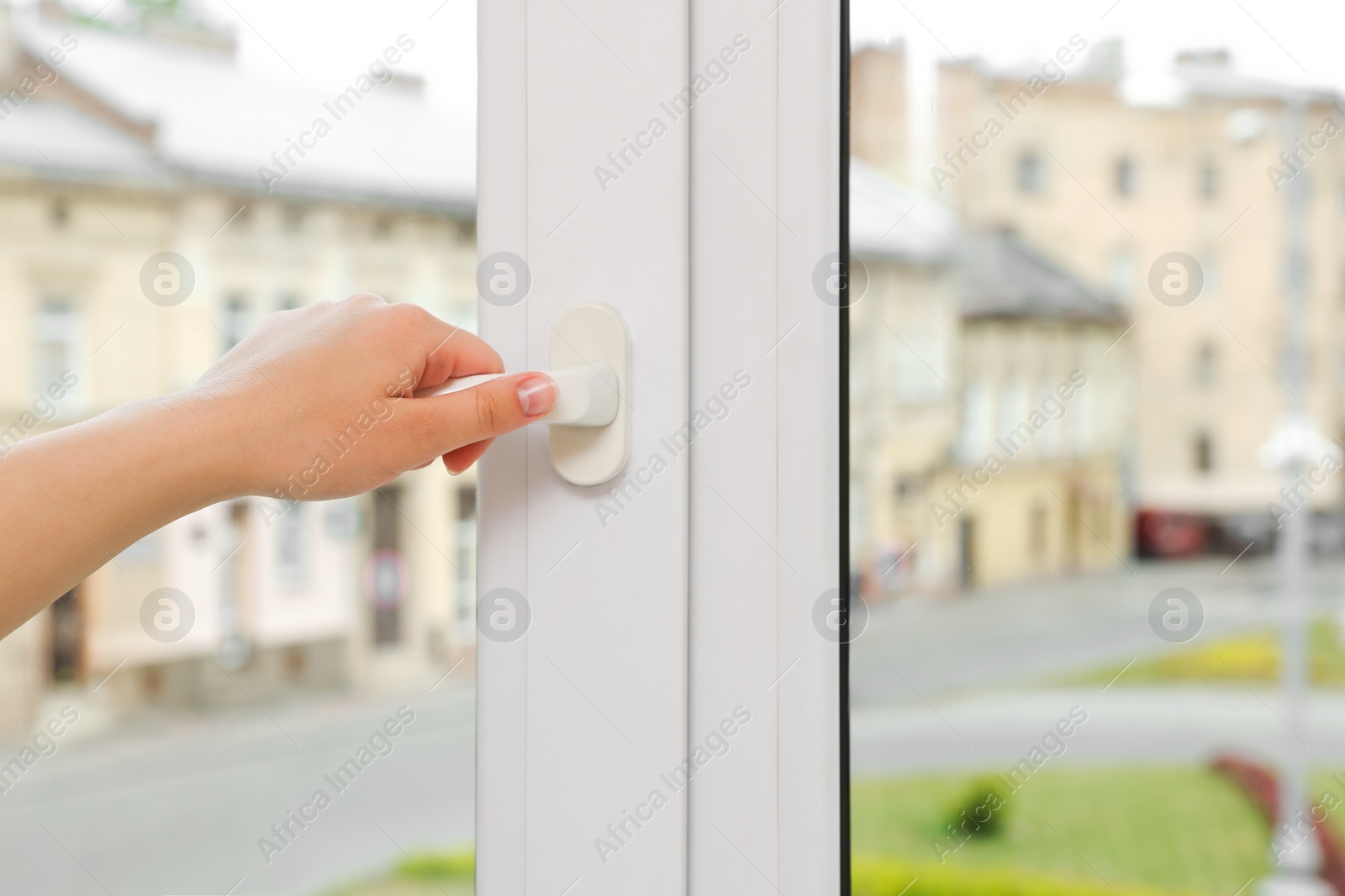 Photo of Woman opening white plastic window at home, closeup