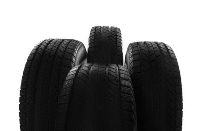 Photo of Set of new winter tires on white background, closeup