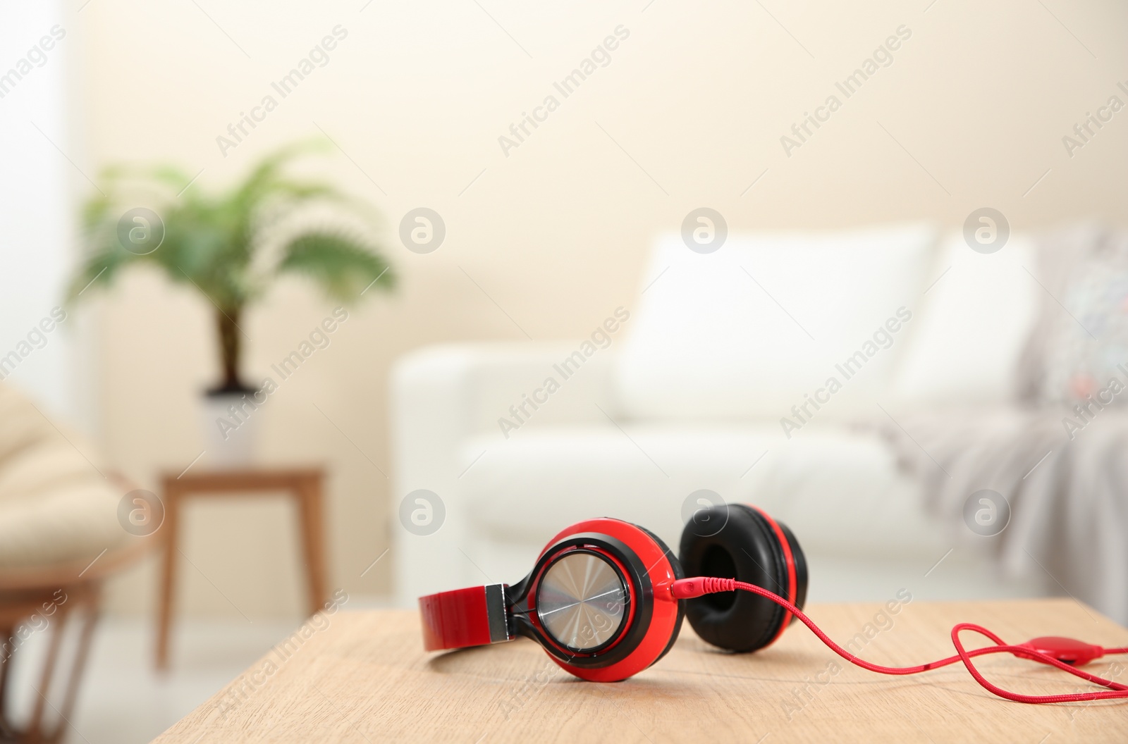 Photo of Stylish headphones on table indoors. Space for text