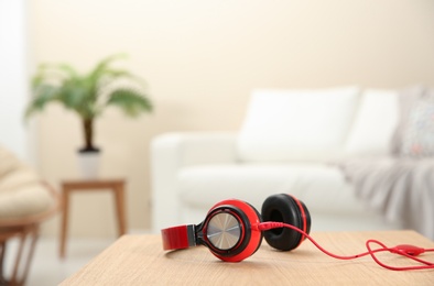 Photo of Stylish headphones on table indoors. Space for text