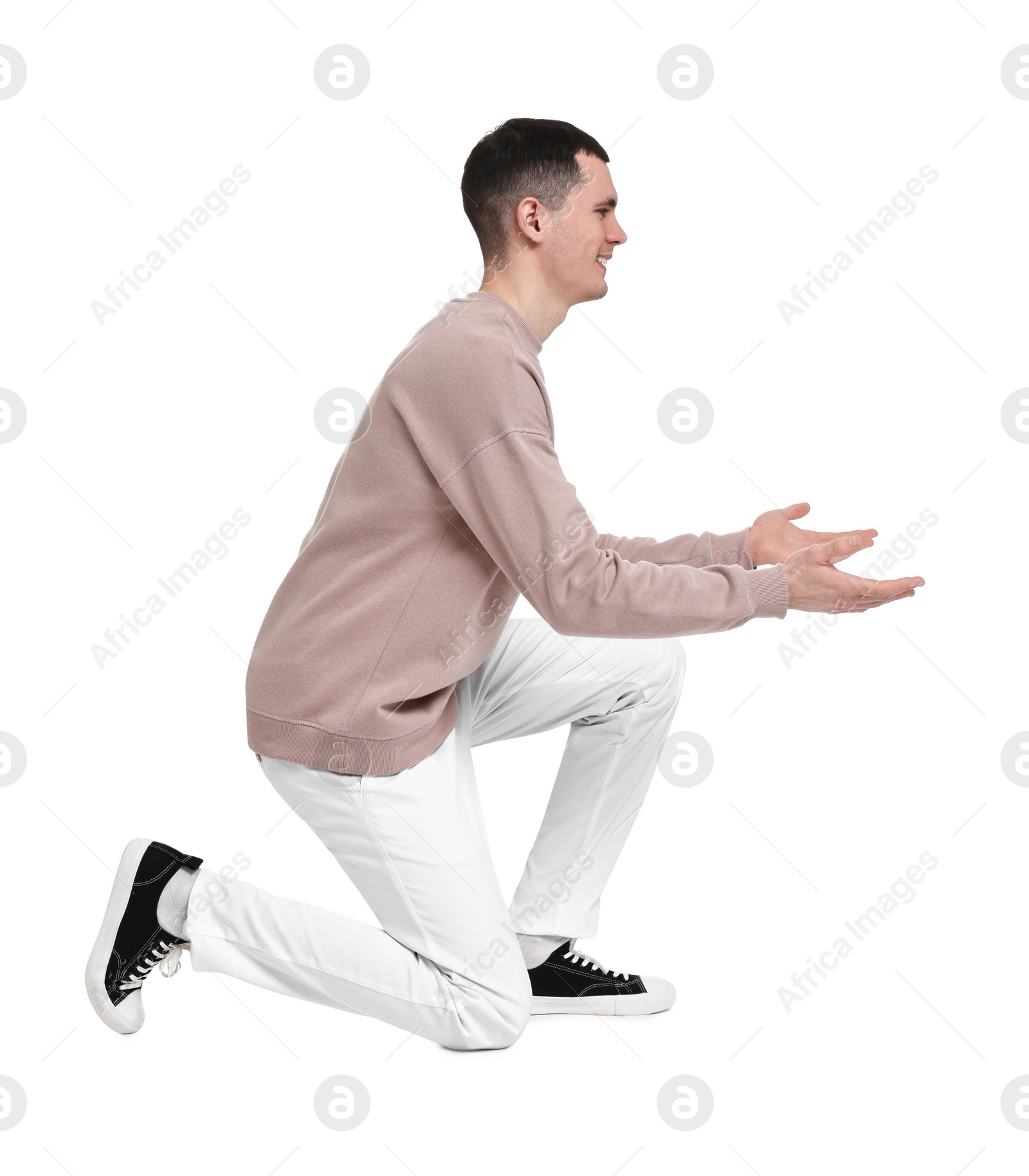 Photo of Handsome young man greeting someone on white background