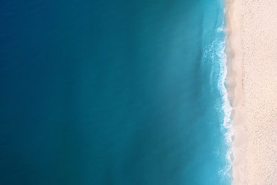 Image of Aerial view of beautiful sea and sandy beach on sunny day