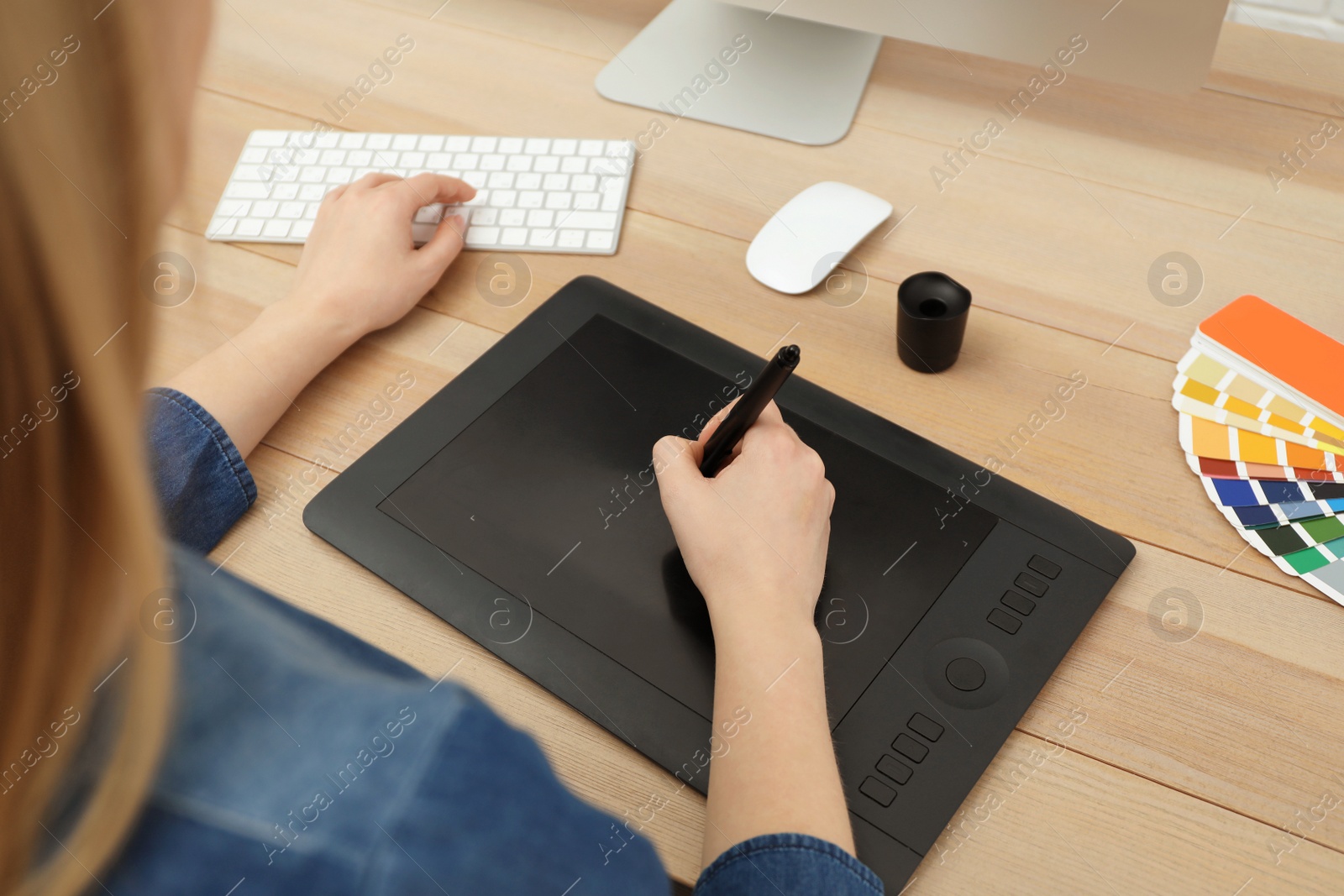 Photo of Professional designer working on graphic tablet at desk, closeup