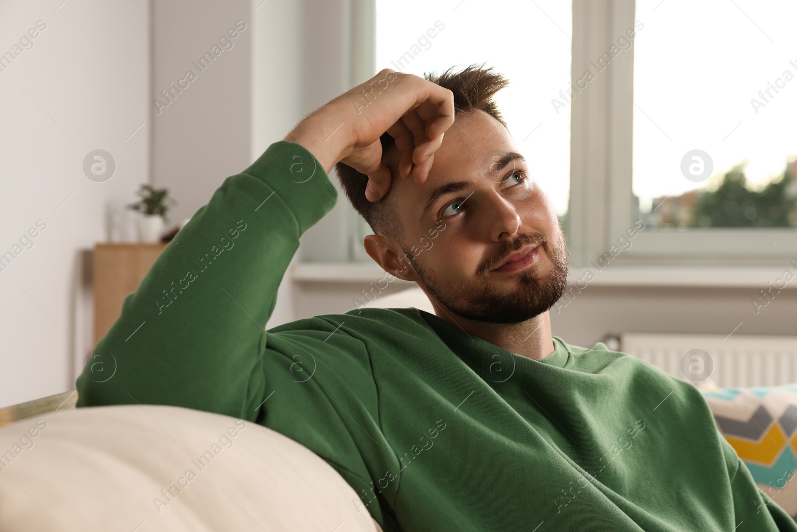 Photo of Portrait of handsome man on sofa at home