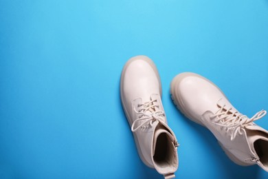 Photo of Pair of stylish leather shoes on light blue background, flat lay. Space for text