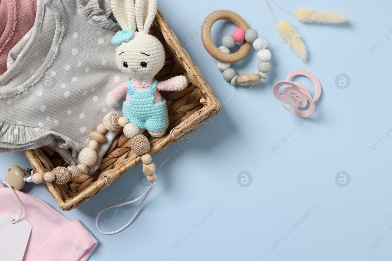 Photo of Flat lay composition with different baby accessories on light blue background, space for text