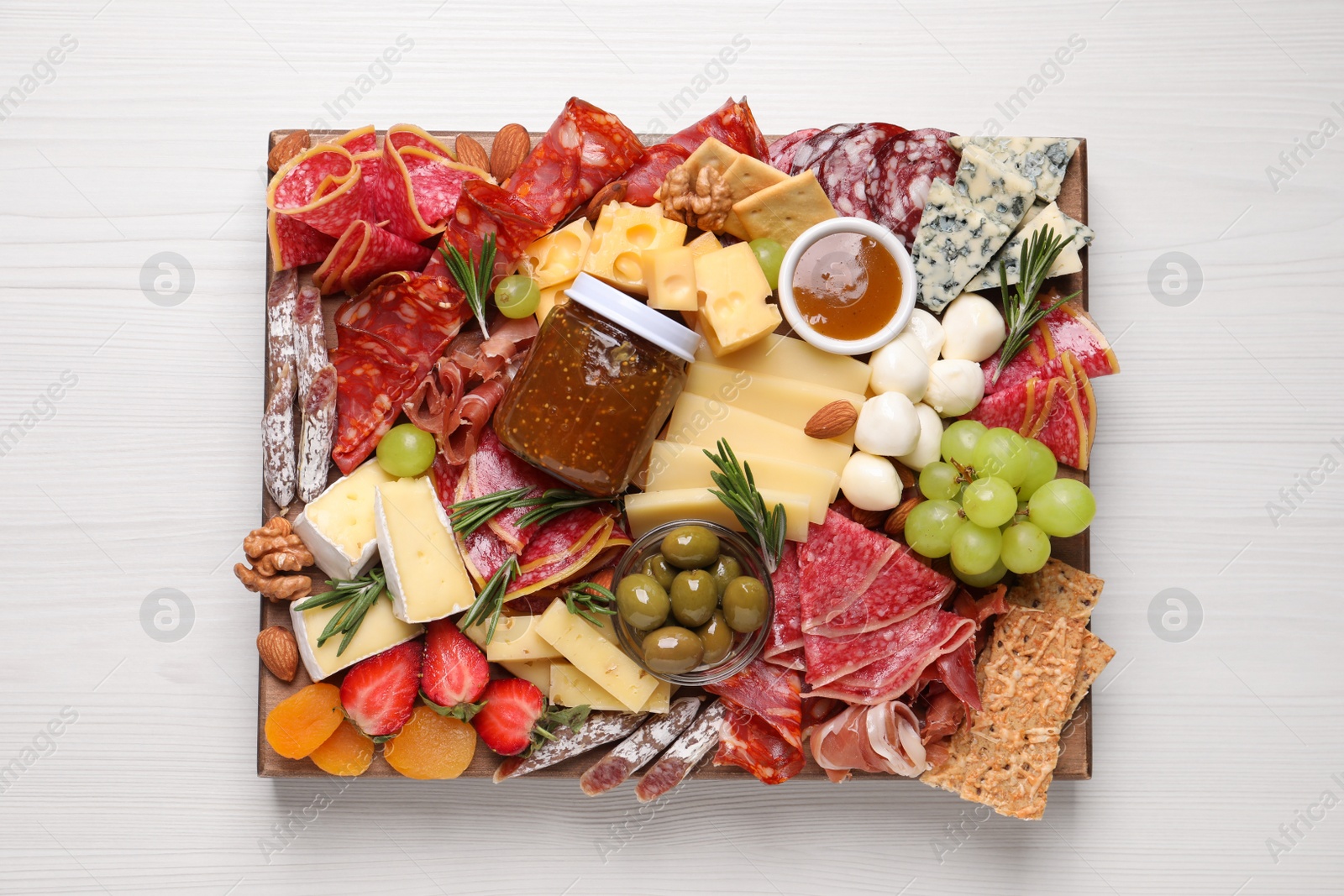 Photo of Assorted appetizer served on white wooden table, top view