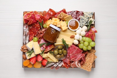 Photo of Assorted appetizer served on white wooden table, top view