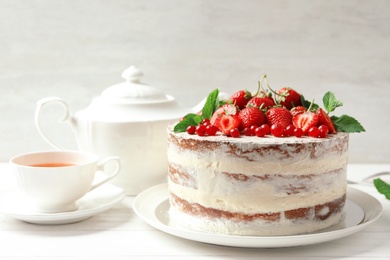 Delicious homemade cake with fresh berries served on wooden table