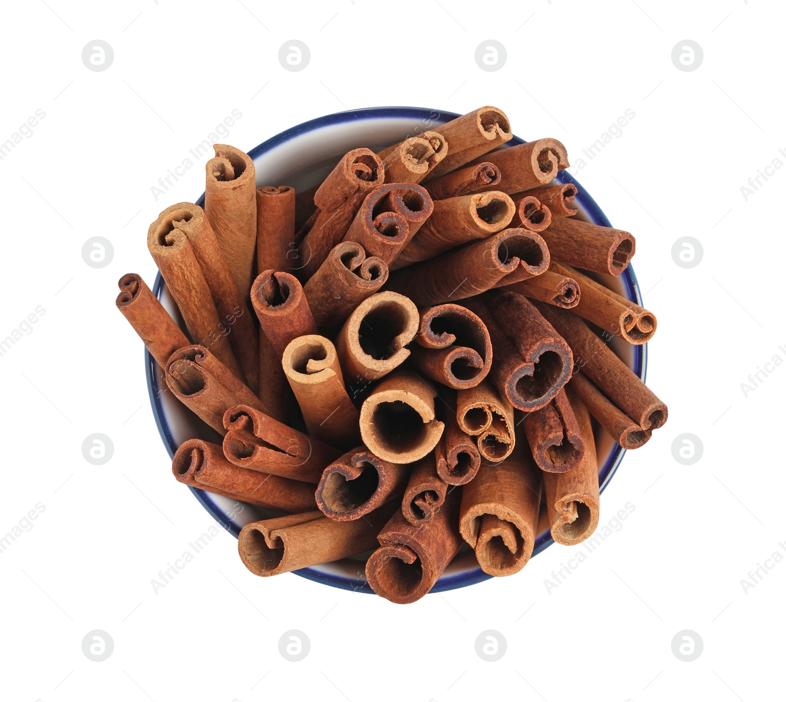 Photo of Cinnamon sticks in bowl isolated on white, top view