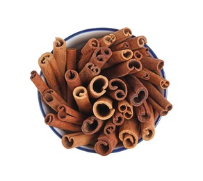 Photo of Cinnamon sticks in bowl isolated on white, top view