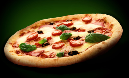 Image of Hot tasty pizza Diablo on dark background. Image for menu or poster