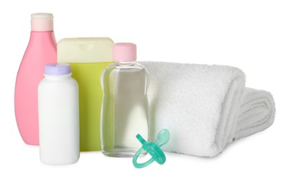 Photo of Bottles of baby cosmetic products, towels and pacifier on white background