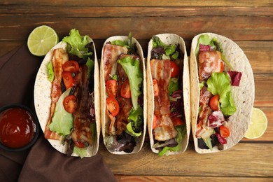 Photo of Delicious tacos with fried bacon and lime on wooden table, flat lay