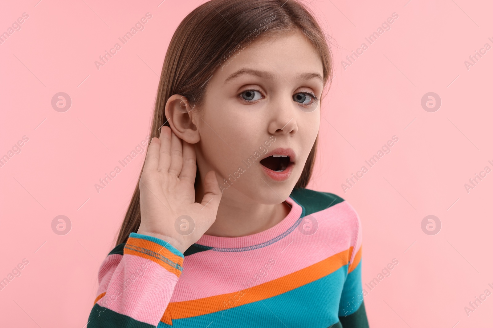 Photo of Little girl with hearing problem on pink background