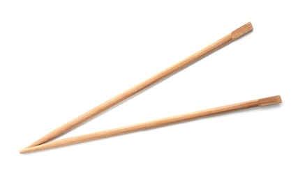 Photo of Chopsticks made of bamboo on white background, top view