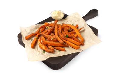 Board with delicious sweet potato fries and sauce on white background