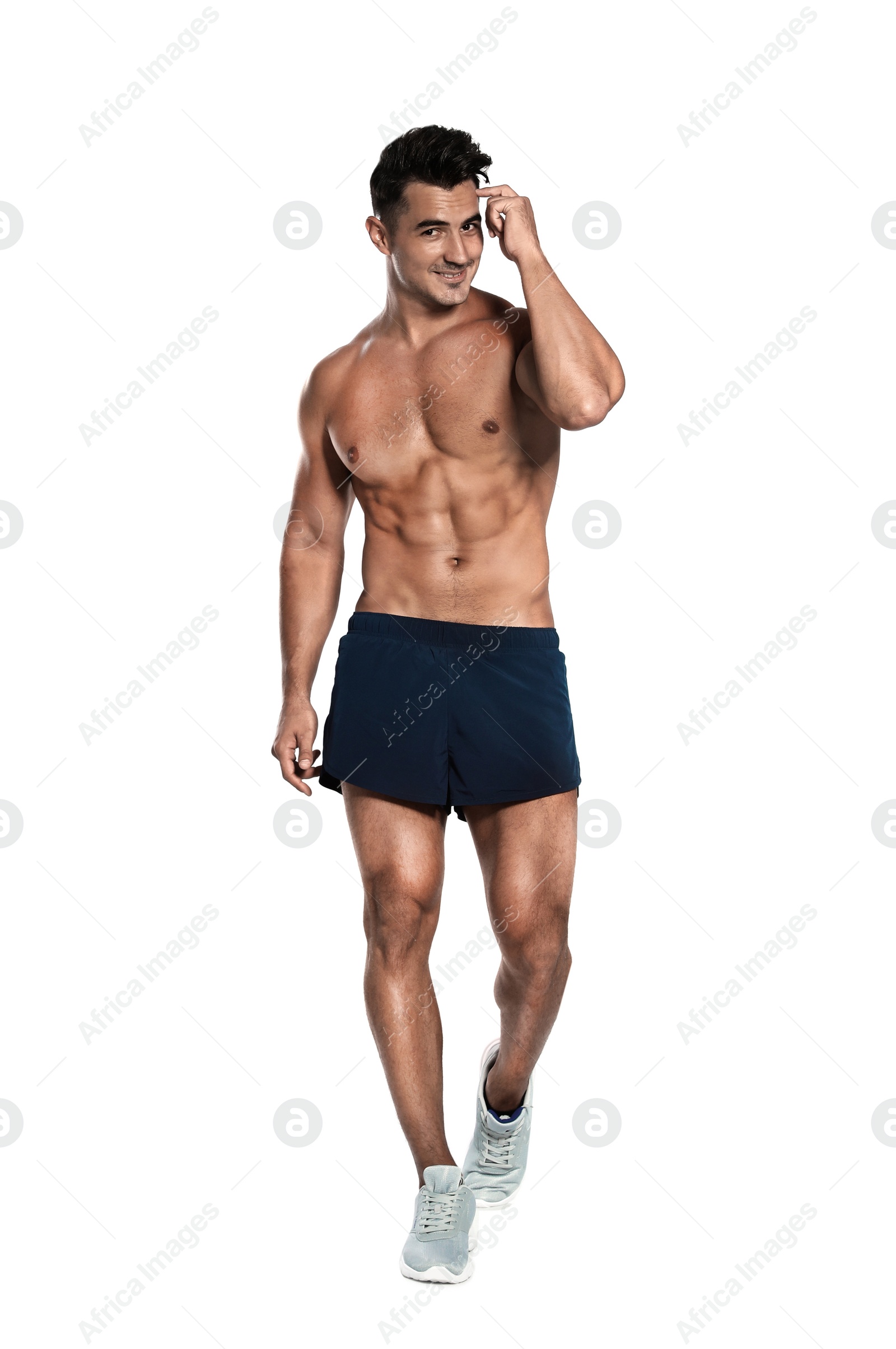 Photo of Handsome young runner posing on white background