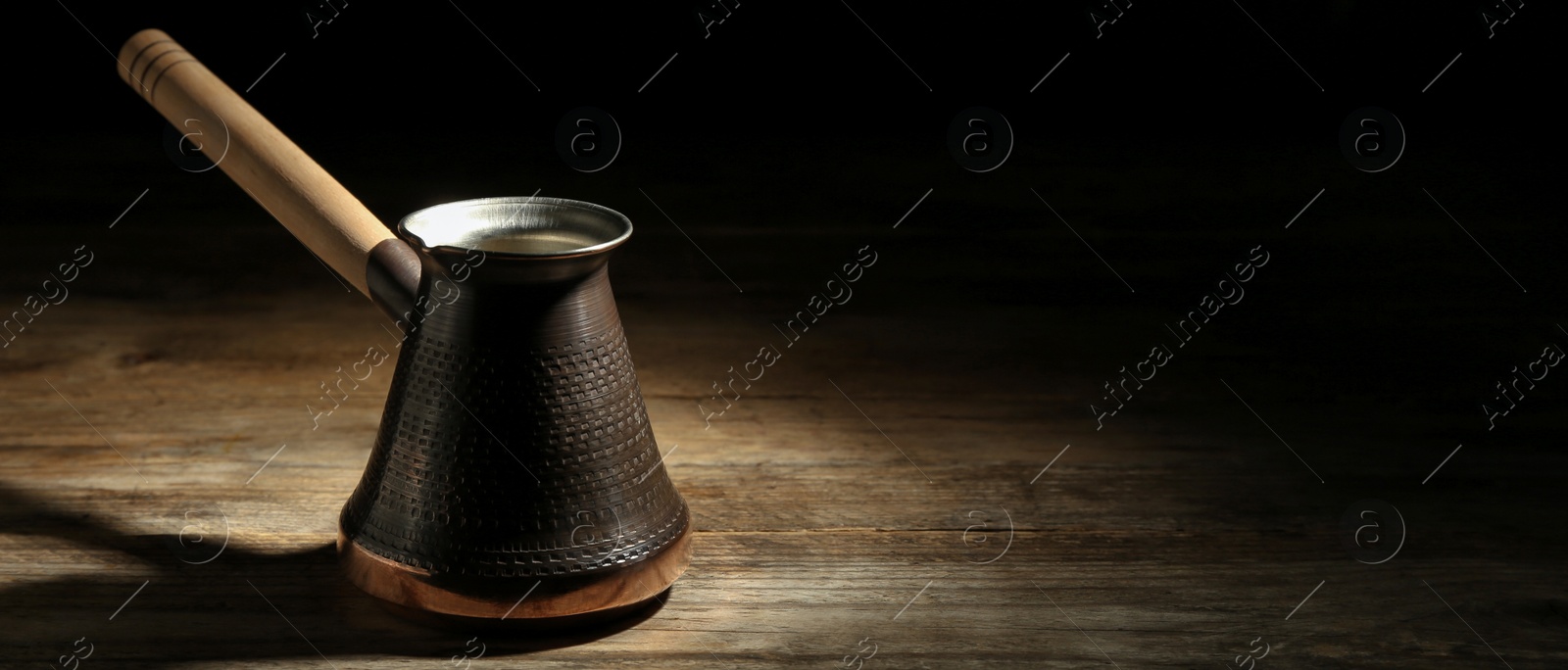 Image of Turkish coffee. Cezve on wooden table. Banner design with space for text