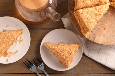 Photo of Delicious Napoleon cake served on wooden table, flat lay