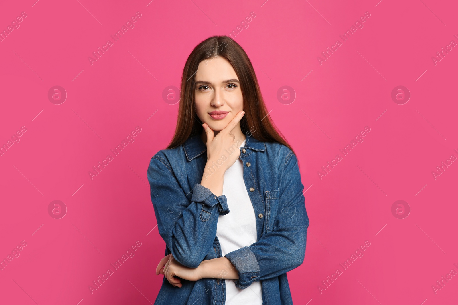 Photo of Pensive woman on pink background. Thinking about answer for question