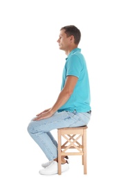 Photo of Man with good posture sitting on stool against white background