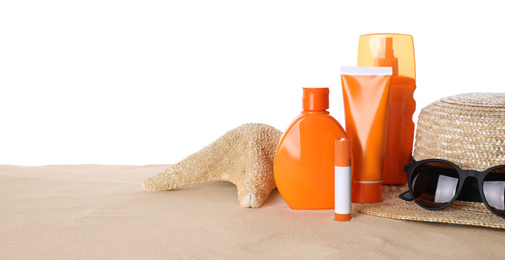 Photo of Sun protection cosmetic products and beach accessories on sand. Space for text