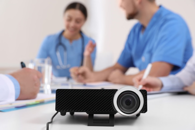 Photo of Video projector on table during medical conference