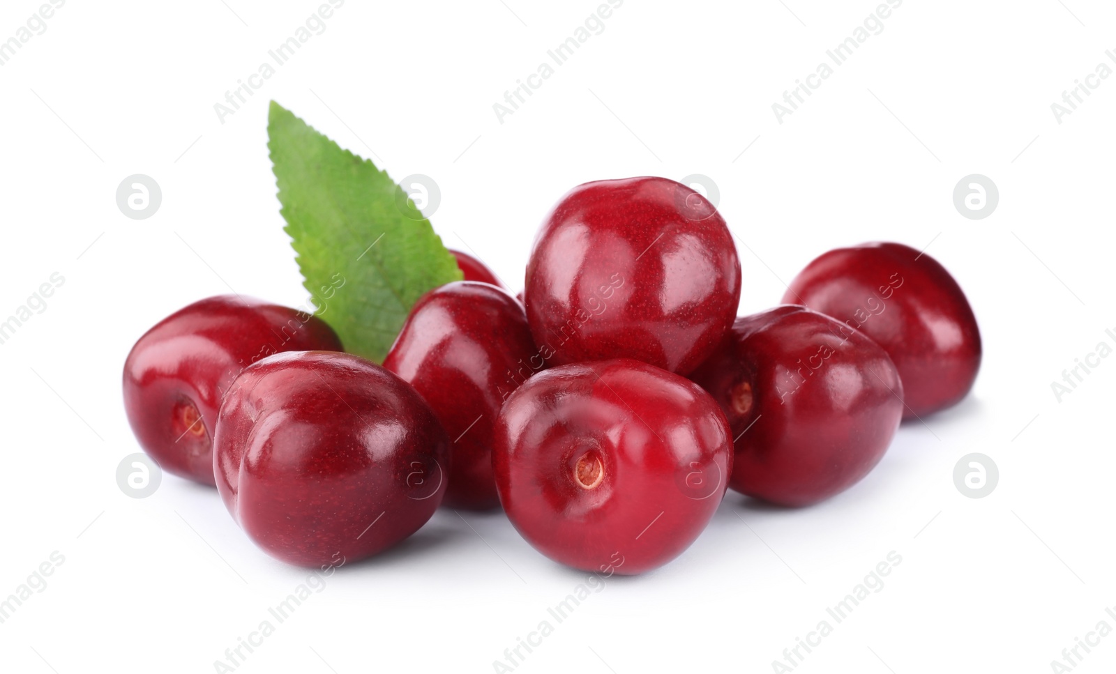 Photo of Tasty ripe red cherries with green leaf isolated on white