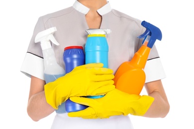 Photo of Young chambermaid with detergents on white background