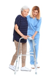 Photo of Caretaker helping elderly woman with walking frame on white background