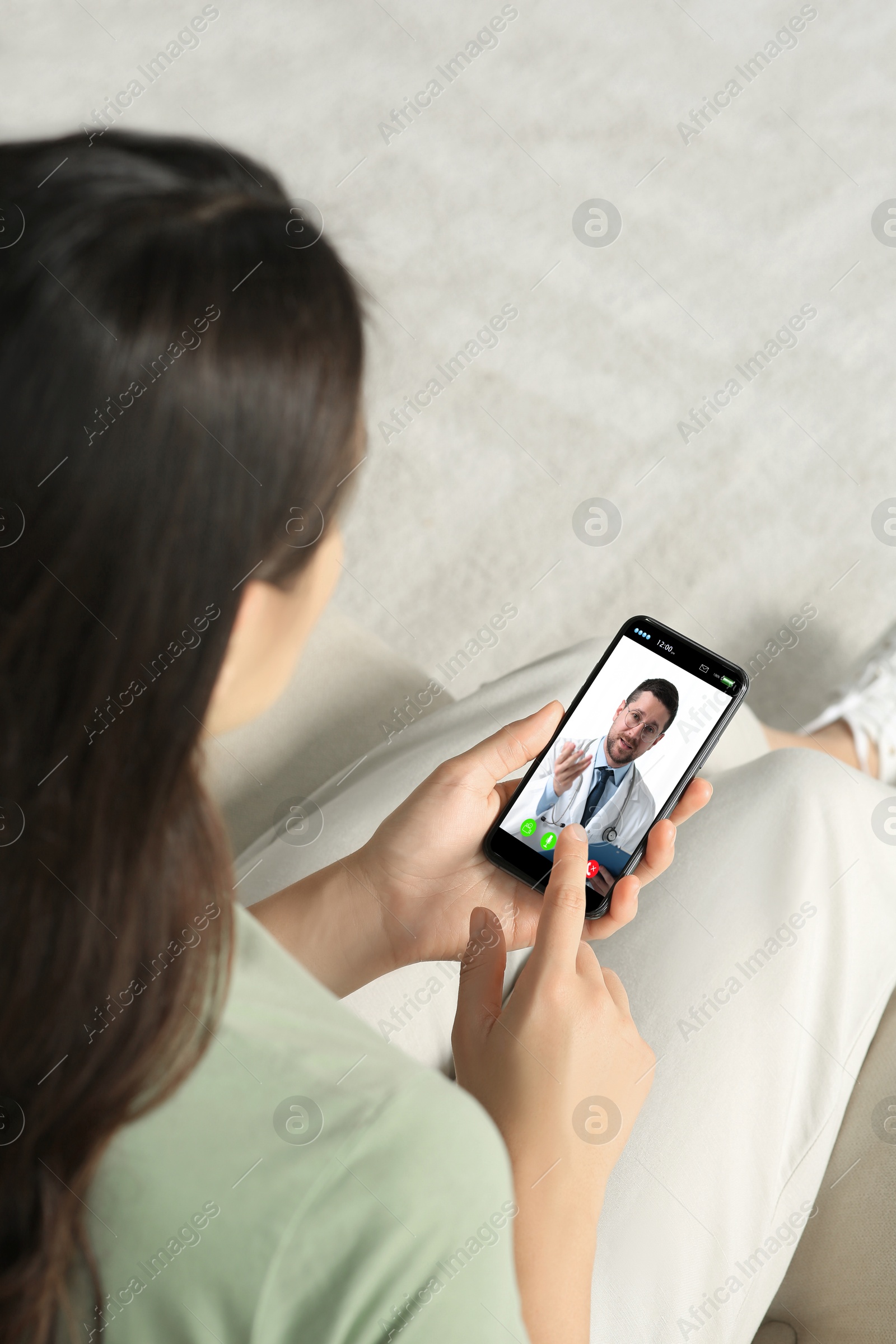 Image of Online medical consultation. Woman having video chat with doctor via smartphone at home