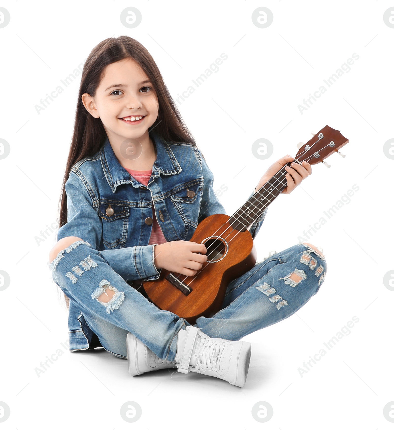 Photo of Little cheerful girl playing guitar, isolated on white