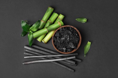 Fresh bamboo and charcoal on black background, flat lay