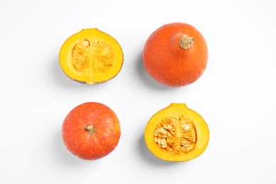 Photo of Fresh ripe pumpkins on white background, top view. Holiday decoration